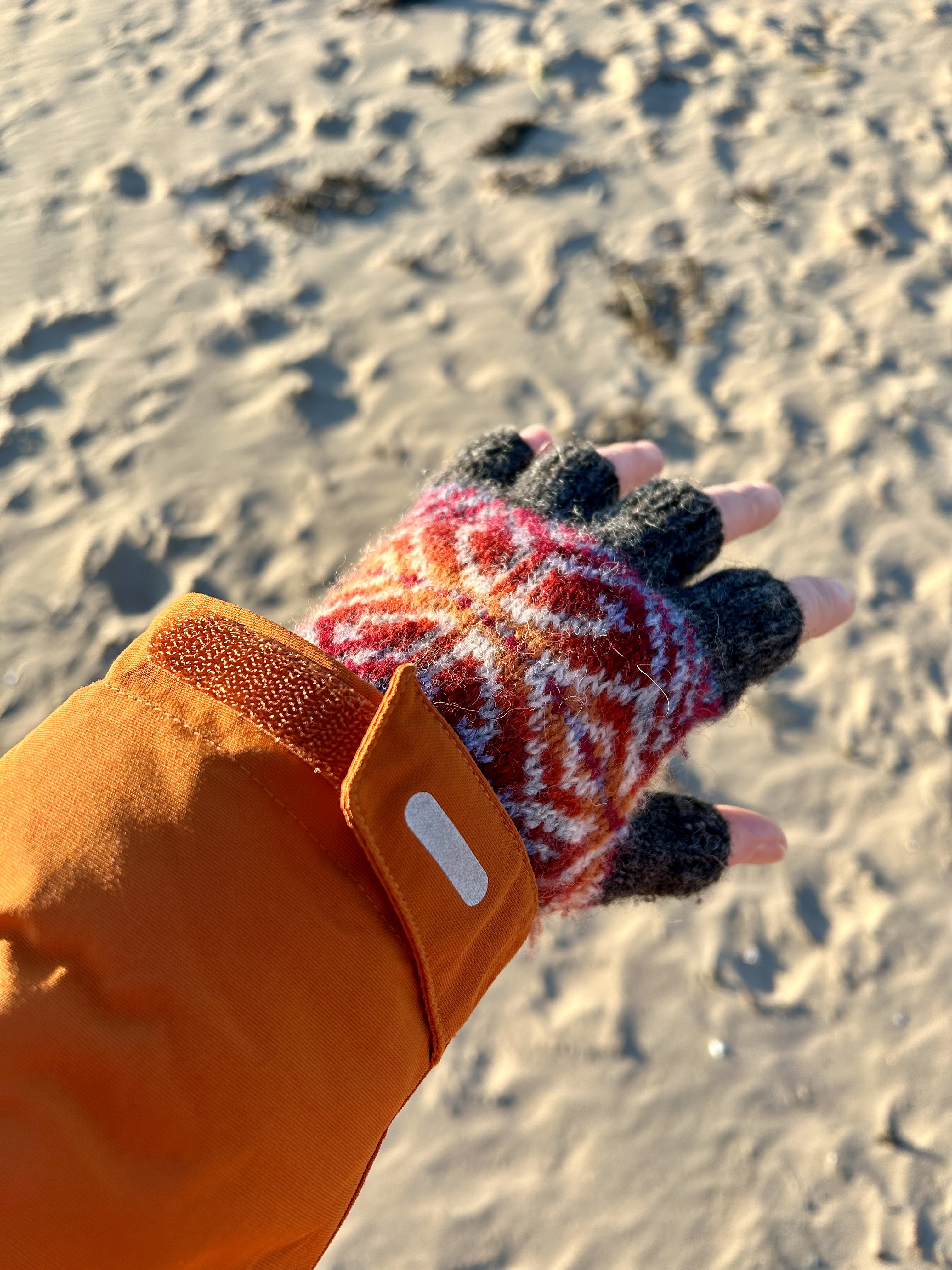 Red and orange fair isle fingerless gloves.