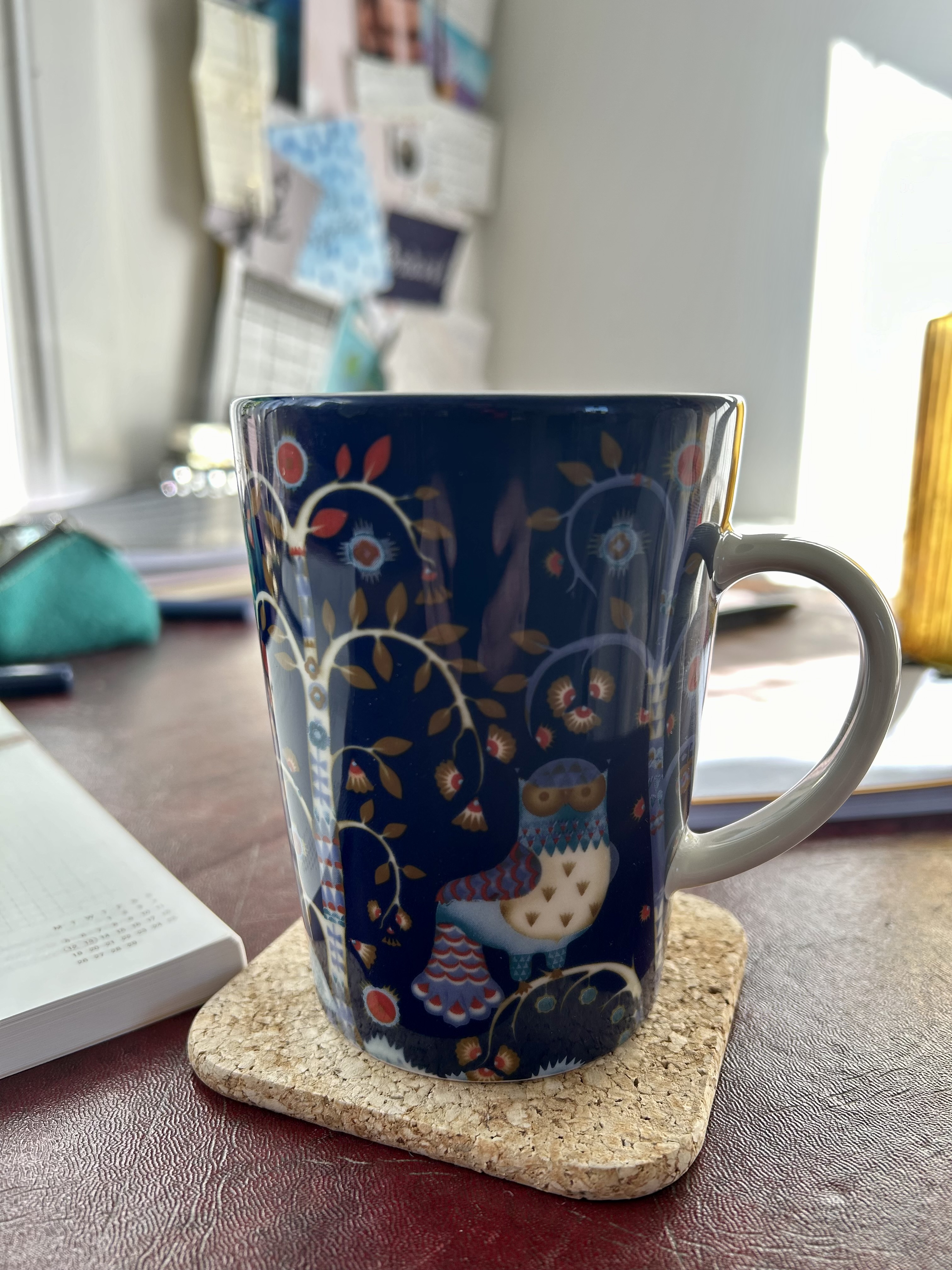 Large, deep blue, ceramic mug, featuring Scandinavian designs of trees and an owl.