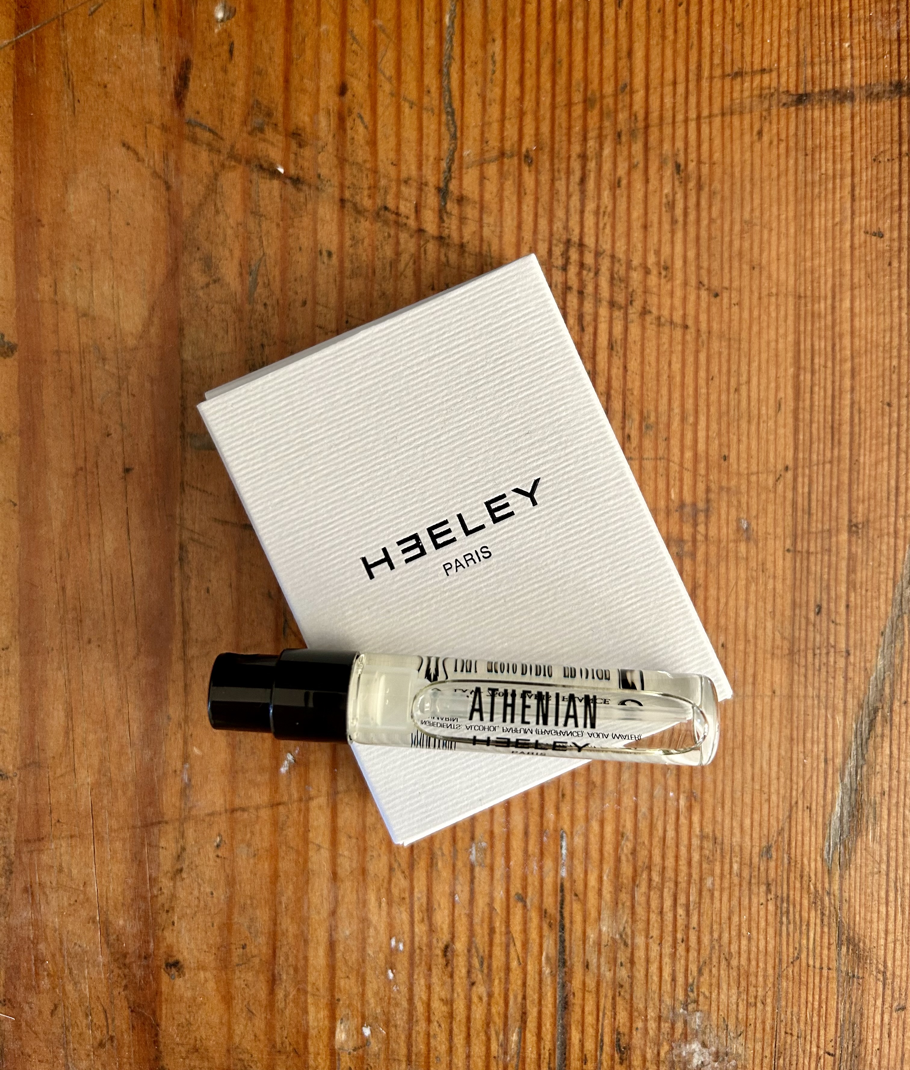 A sample vial and packaging of Athenean (vial reads Athenian) perfume by Heeley Paris.