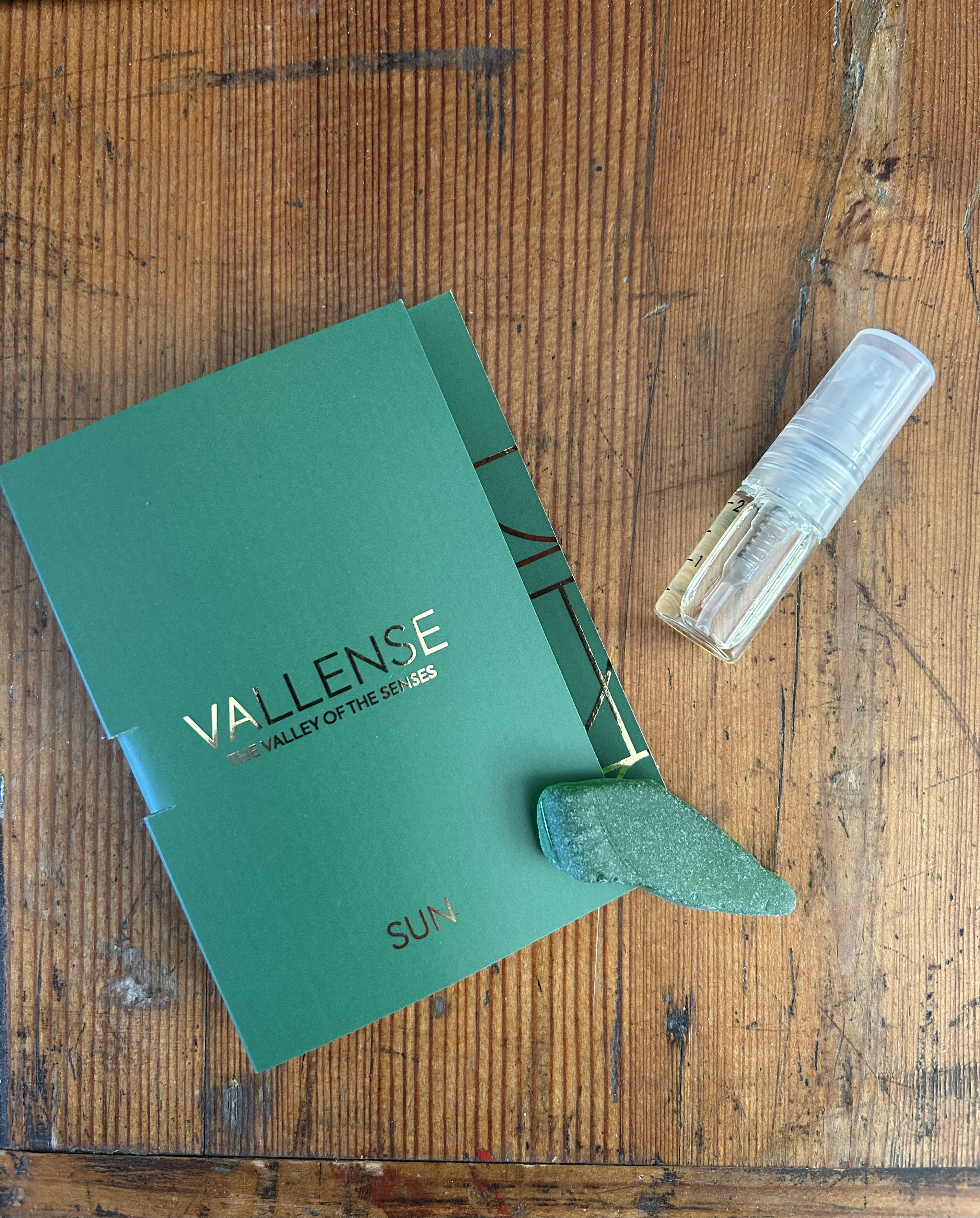 perfume sample of Sun by Vallense with a piece of seaglass
